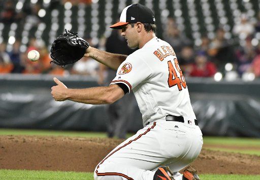 Baltimore Orioles relief pitcher Richard Bleier bobbles the grounder single by Cleveland Indians\