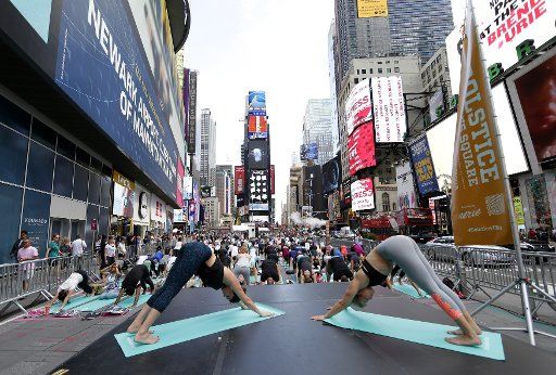 People participate in yoga classes in Times Square to celebrate the Summer Solstice on the first day of Summer in New York City on June 21, 2017. Thousands of yogis will participate in eight yoga classes during the 15th annual Solstice in Times ...