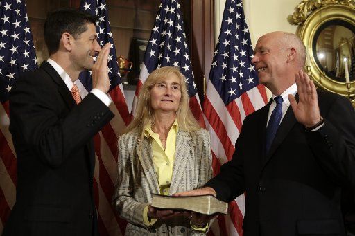 House Speaker Paul Ryan (R-WI) (L) holds ceremonial swearing-in for Rep.-elect Greg Gianforte as his wife Susan participates on Capitol Hill in Washington on June 21, 2017. Photo by Yuri Gripas\/