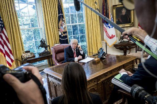 President Donald Trump waits to speak with Prime Minister Leo Varadkar of Ireland by telephone in the Oval Office at the White House on June 27, 2017 in Washington, DC. Trump made the call to congratulate the newly elected Prime Minister and current ...