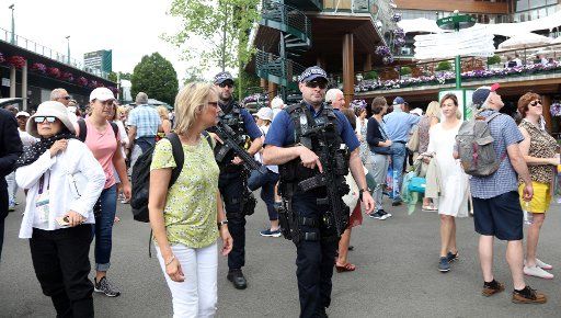 Armed police roam amongst tennis fans amidst recent terrorist attacks on day Two of the 2017 Wimbledon championships, London on July 4, 2017. Photo by Hugo Philpott\/