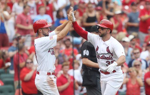 St. Louis Cardinals Greg Garcia is welcomed at home plate by Paul DeJong after hitting a two run home run in the fifth inning against the Miami Marlins at Busch Stadum in St. Louis on July 4, 2017. Photo by Bill Greenblatt\/