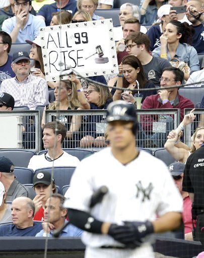 fans hold up signs as New York Yankees Aaron Judge steps up to the plate 6th inning against the Oakland Athletics at Yankee Stadium in New York City on May 27, 2017. Photo by John Angelillo\/