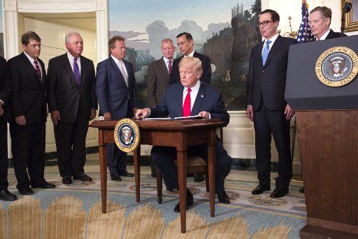 U.S. President Donald J. Trump signs a memorandum on addressing China\