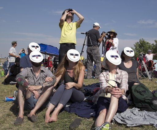 Eclipse viewers wear paper plate safety viewers as they watch the total solar eclipse in Casper, Wyoming. August 22, 2017 Photo by Mark Abraham\/