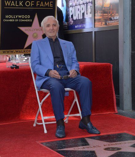 French singer and actor Charles Aznavour holds court with photographers and reporters during an unveiling ceremony honoring him with the 2,618th star on the Hollywood Walk of Fame in Los Angeles on August 24, 2017. Photo by Jim Ruymen\/