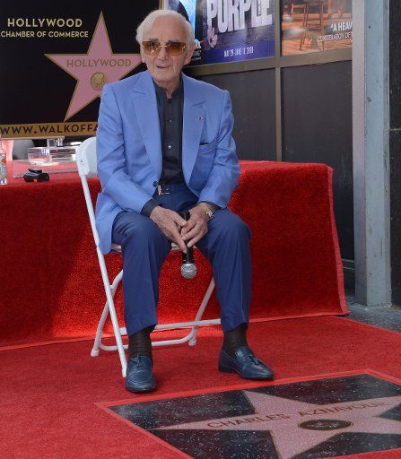 French singer and actor Charles Aznavour holds court with photographers and reporters during an unveiling ceremony honoring him with the 2,618th star on the Hollywood Walk of Fame in Los Angeles on August 24, 2017. Photo by Jim Ruymen\/