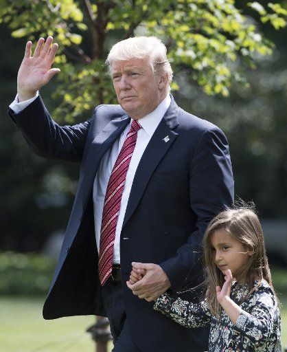 President Donald Trump holds hands with his granddaughter Arabella Rose Kushner as they departs the White House for a weekend trip to Camp David, in Washington, D.C. on August 25, 2017. Photo by Kevin Dietsch\/