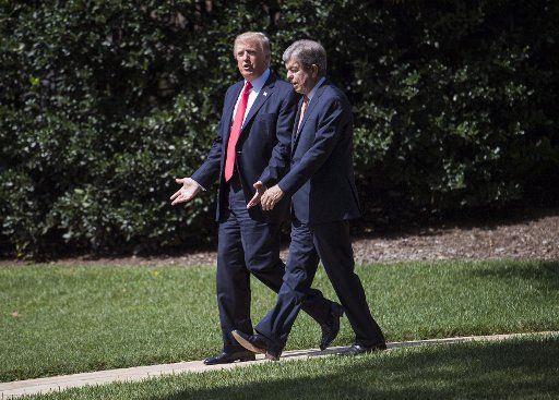 President Donald Trump (L) walks with Sen. Roy Blunt, R-MO, as they depart the White House for a day trip to Springfield, Missouri, on the South Lawn of the White House in Washington, D.C. on August 30, 2017. Photo by Kevin Dietsch\/