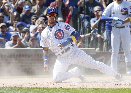 Chicago Cubs Javier Baez smiles after scoring on a single hit by Kyle Schwarber against the Atlanta Braves in the third inning at Wrigley Field on September 1, 2017 in Chicago. Photo by Kamil Krzaczynski\/