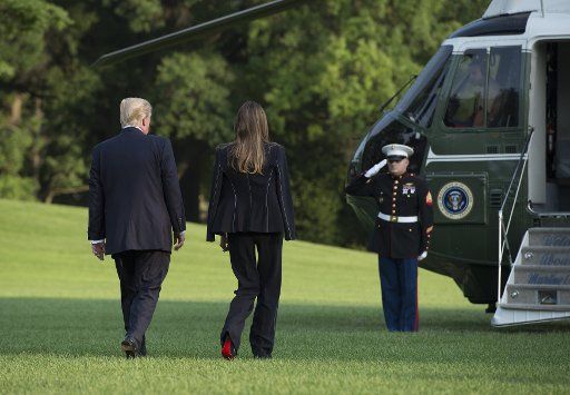 President Donald Trump and first lady Melanie leave the White House to board Marine One to Joint Base Andrews for their trip to France, in Washington D.C., July 12, 2017. Photo by Molly Riley\/