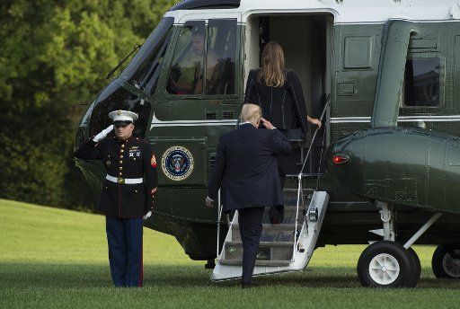 President Donald Trump and first lady Melania board Marine One on the South Lawn of the White House as they leave for their trip to France, in Washington D.C., July 12, 2017. Photo by Molly Riley\/