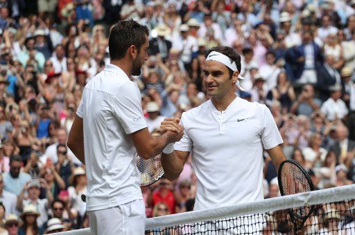 Swiss Roger Federer consoles Croat Marin Cilic after victory in the 2017 Wimbledon championships, London on July 16, 2017. Federer beat Cilic 6-3, 6-1, 6-4, to win his eighth Wimbledon Men\