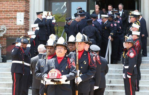 St. Louis Fire Department Honor Guard members lead a procession for St. Louis fire captain John Kemper following funeral services at Harris Stowe State College in St. Louis on July 21, 2017. Kemper died on July 12, following injuries he sustained at ...