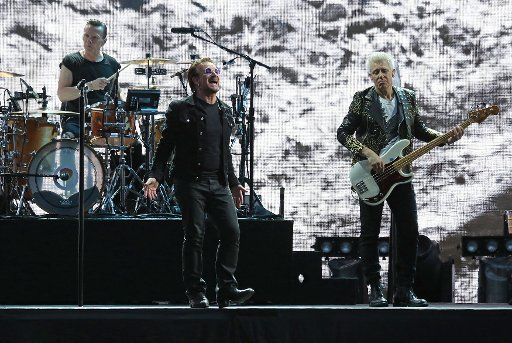 U2 members Larry Mullen Jr (L), Bono (C) and Adam Clayton perform in concert at the Stade de France near Paris on July 25, 2017. Photo by David Silpa\/