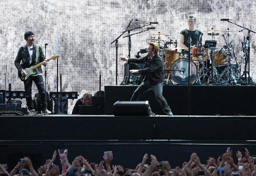U2 members The Edge (L), Bono (C) and Larry Mullen Jr perform in concert at the Stade de France near Paris on July 25, 2017. Photo by David Silpa\/