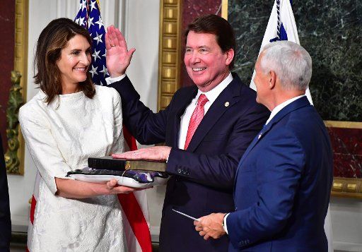 Vice President Mike Pence swears-in William Hagerty (C) as the U.S. Ambassador to Japan as his wife Chrissy watches, during a ceremony in the Eisenhower Executive Office Building in Washington, D.C. on July 27, 2017. Photo by Kevin Dietsch\/