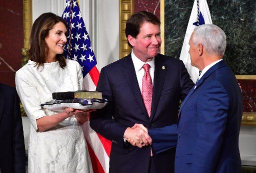 Vice President Mike Pence shakes hands with William Hagerty (C), the U.S. Ambassador to Japan as his wife Chrissy watches, during his swearing-in ceremony in the Eisenhower Executive Office Building in Washington, D.C. on July 27, 2017. Photo by ...