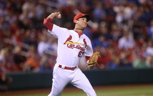 St. Louis Cardinals Matt Bowman makes an errant throw to first base trying to get Chicago Cubs Kyle Schwarber who hit a slow roller in the 11th inning at Busch Stadium in St. Louis on September 28, 2017. Chicago defeated St. Louis 2-1. Photo by Bill ...