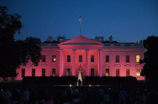 The White House is illuminated with pink light in honor of National Breast Cancer Awareness Month, in Washington, D.C. on October 1, 2017. Photo by Kevin Dietsch\/