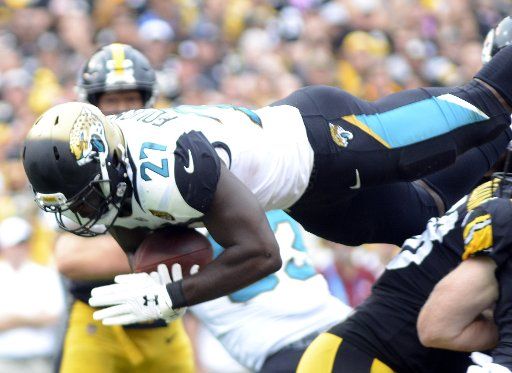 Jacksonville Jaguars running back Leonard Fournette (27) dives over the Pittsburgh Steelers defense for a two yard touchdown in the second quarter at Heinz Field in Pittsburgh on October 8, 2017. Photo by Archie Carpenter\/