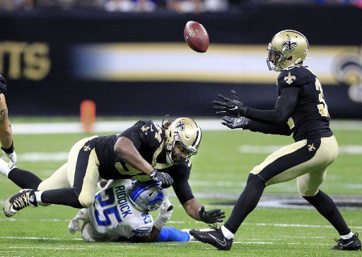 New Orleans Saints defensive end Cameron Jordan (94) tips the ball away from Detroit Lions cornerback Nevin Lawson (24) into the waiting arms of strong safety Kenny Vaccaro (32) late in the fourth quarter at the Mercedes-Benz Superdome in New ...