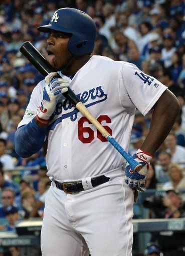 Los Angeles Dodgers right fielder Yasiel Puig licks his bat in the fourth inning against the Chicago Cubs in game 2 of the NLCS at Dodger Stadium in Los Angeles on October 15, 2017. The Dodgers hold a 1-0 series lead over the Cubs. Photo by Jim ...