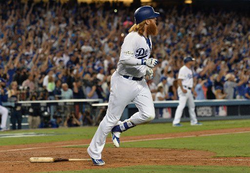 Los Angeles Dodgers third baseman Justin Turner hits a walk off three-run home run against the Chicago Cubs in the ninth inning of game 2 of the NLCS at Dodger Stadium in Los Angeles on October 15, 2017. The Dodgers beat the Cubs 4-1 to take a 2-0 ...