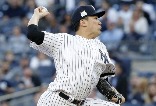 New York Yankees starting pitcher Masahiro Tanaka throws a pitch in the first inning against the Houston Astros in game 5 of the 2017 MLB Playoffs American League Championship Series at Yankee Stadium in New York City on October 18, 2017. Photo ...