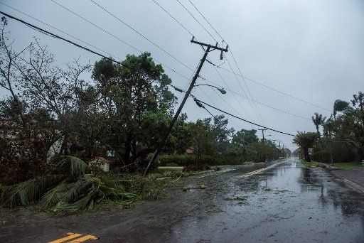 A power pole leans into a debris covered street after hurricane Irma made its way through Delray Beach, Florida on September 10, 2017. Irma is hitting the west coast of Florida. Photo by Ken Cedeno\/