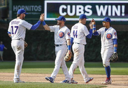 Chicago Cubs players celebrate after defeating the St. Louis Cardinals at Wrigley Field on September 15, 2017 in Chicago. Photo by Kamil Krzaczynski\/