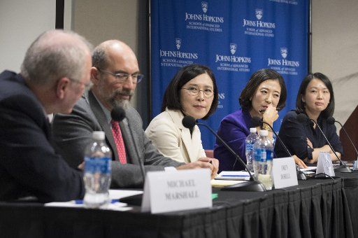 Michael Marshall (L), Editor Emiritus of United Press International, moderates a discussion regarding the challenges of reporting news in North and South Korea, during event at the John Hopkins School of Advanced International Studies in Washington, ...