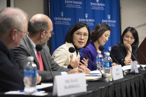 Chosun Ilbo Washington Bureau Chief Kang Insun (C) makes a comment during a Korean discussion forum regarding the challenges of reporting news in North and South Korea, during event at the John Hopkins School of Advanced International Studies in ...