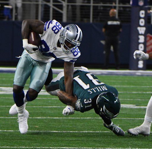 Dallas Cowboys Dez Byant gets dragged down by Philadelphia Eagles Jalen Millis after a short gian during the first half at AT&T Stadium in Arlington, Texas on November 19, 2017. Photo by Ian Halperin\/