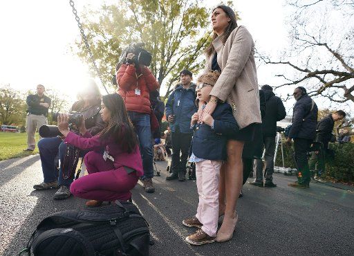 White House Press Secretary Sarah Huckabee Sanders holds her son Puck as they watch President Donald Trump and the First Family depart the White House on Marine One, at the White House on November 22, 2017 in Washington, D.C. The First Family is on ...
