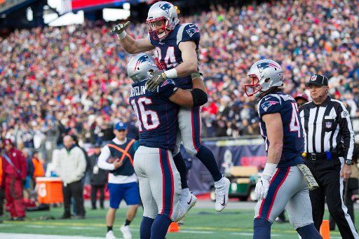 New England Patriots running back Rex Burkhead (34) is picked up by fullback James Develin (46) after Bulkhead scored in the second quarter against the Miami Dolphins at Gillette Stadium in Foxborough, Massachusetts on November 26, 2017. Photo by ...