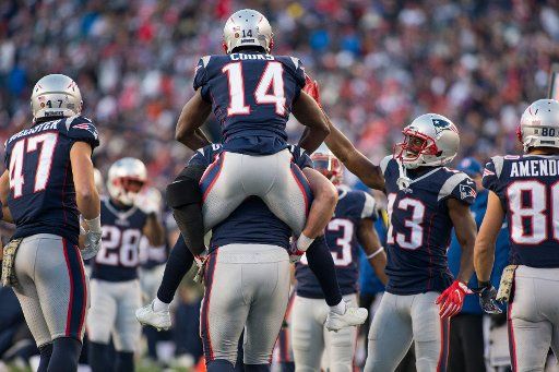 New England Patriots wide receiver Brandin Cooks (14) gets a ride from tight end Rob Gronkowski and a high five from wide receiver Phillip Dorsett (14) after Cooks scored a touchdown in the fourth quarter against the Miami Dolphins at Gillette ...