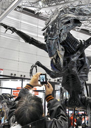 A man takes a photo for replica of Alien at the Tokyo Comic Con 2017 in Chiba, Japan on December 2, 2017. Photo by keizo Mori\/