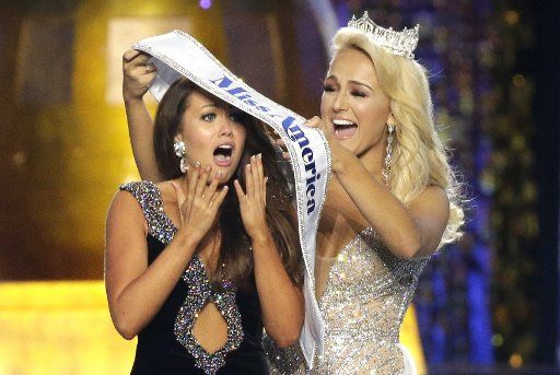 2017 Miss America Savvy Shields puts the Miss America Sash on Miss North Dakota Cara Mund who wins the 97th annual 2018 Miss America Competition at Boardwalk Hall in Atlantic City, NJ, on September 10, 2017. Photo by John Angelillo\/