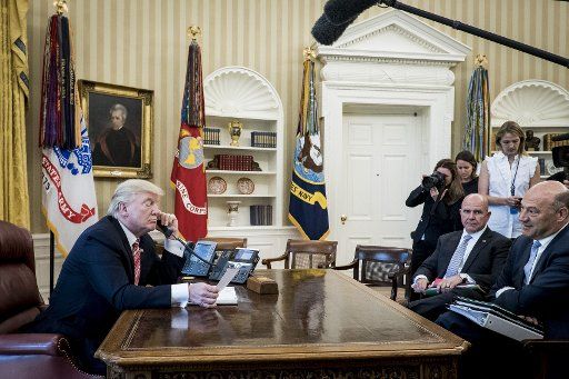 U.S. National Security Advisor H.R. McMaster and chief economic advisor Gary Cohn (right) look on as President Donald Trump speaks with Prime Minister Leo Varadkar of Ireland by telephone in the Oval Office at the White House on June 27, 2017 in Washington, D.C. Trump made the call to congratulate the newly elected Prime Minister and current Taoiseach. The leader of the Fine Gael Party, Varadkar was elected following the retirement of Enda Kenny. Photo by Pete Marovich\/