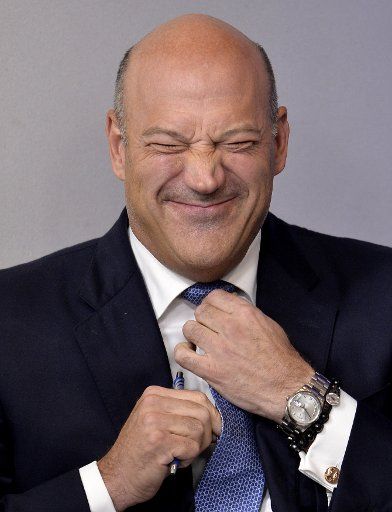White House Economic Council Director Gary Cohn makes a face as he adjusts his tie, as he arrives for the daily press briefing, at the White House, September 28, 2017, in Washington, DC. Cohn briefed the press on the outline of President Trump\