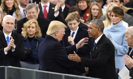 President Donald Trump greets former President Barack Obama after being sworn in as the 45th President of the United States on the steps of the Capitol on January 20, 2017, in Washington, D.C. Photo by Mike Theiler\/