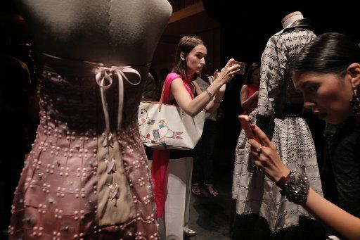 Guests take a close look at mannequins wearing garments made with a new type of textile created by Japanese designer Yuima Nakazato after his show as part of the Fall-Winter 2017-2018 Paris High Fashion on July 5, 2017. Photo by Maya Vidon-White\/