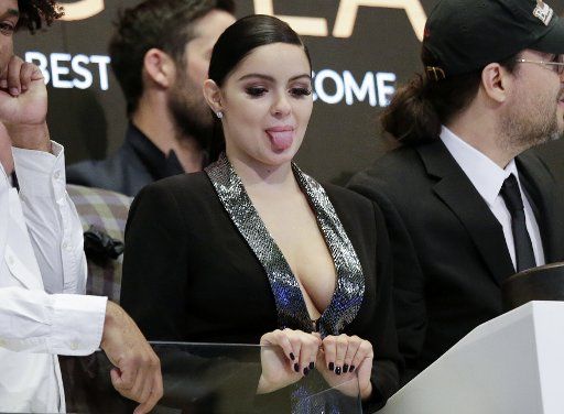 Ariel Winter sticks out her tongue when she and cast members from the film "Dog Years" ring the closing bell at the New York Stock Exchange on Wall Street in New York City on April 24, 2017. The Dow Jones Industrial Average closed up 216 points for the day. Photo by John Angelillo\/