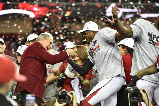 Atlanta Falcons owner Arthur Blank (L) dances with players after defeating the Green Bay Packers 44-21 to win the NFC Championship game at the Georgia Dome on January 22, 2017 in Atlanta. The Falcons advance to Super Bowl 51. Photo by David Tulis\/