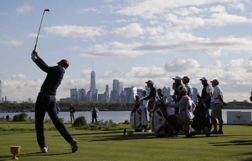 Jordan Spieth of the United States hits his tee shot on the 10th hole with a view of One World Trade Center and the Manhattan Skyline in the morning foursomes matches at the Presidents Cup on September 30, 2017 at Liberty National Golf Club in Jersey City, New Jersey. Photo by John Angelillo\/