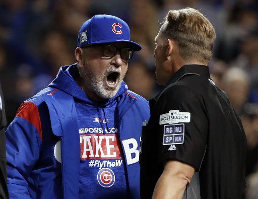 Chicago Cubs manager Joe Madden argues a call with home plate umpire Jim Wolf (R) in the eighth inning against the Los Angeles Dodgers in game 4 of the National League Championship Series at Wrigley Field in Chicago on October 18, 2017. Cubs\