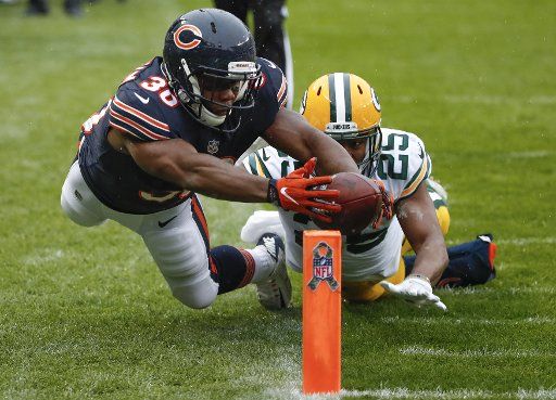 Chicago Bears running back Benny Cunningham (30) steps out of bounds as he attempts to score a touchdown against Green Bay Packers defensive back Marwin Evans (25) during the first half at Soldier Field in Chicago on November 12, 2017. Photo by Kamil Krzaczynski\/