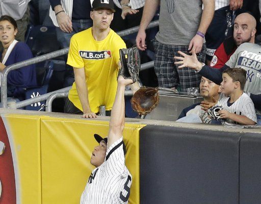 New York Yankees Aaron Judge makes a leaping catch robbing the Cleveland Indians of a home run in the 6th inning in game 3 in the 2017 MLB Playoffs American League Divisional Series at Yankee Stadium in New York City on October 8, 2017. Photo by John Angelillo\/