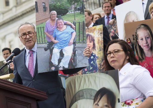 Senate Majority Leader Charles Schumer, D-N.Y. speaks out against the Republican health care bill as he and other Senate Democrats hold photos of people who would lose their health coverage under bill, during a press conference at the U.S. Capitol on June 27, 2017, in Washington, D.C. After lacking votes the Republican leadership has delayed the health care bill vote until after the July 4th recess. Photo by Kevin Dietsch\/